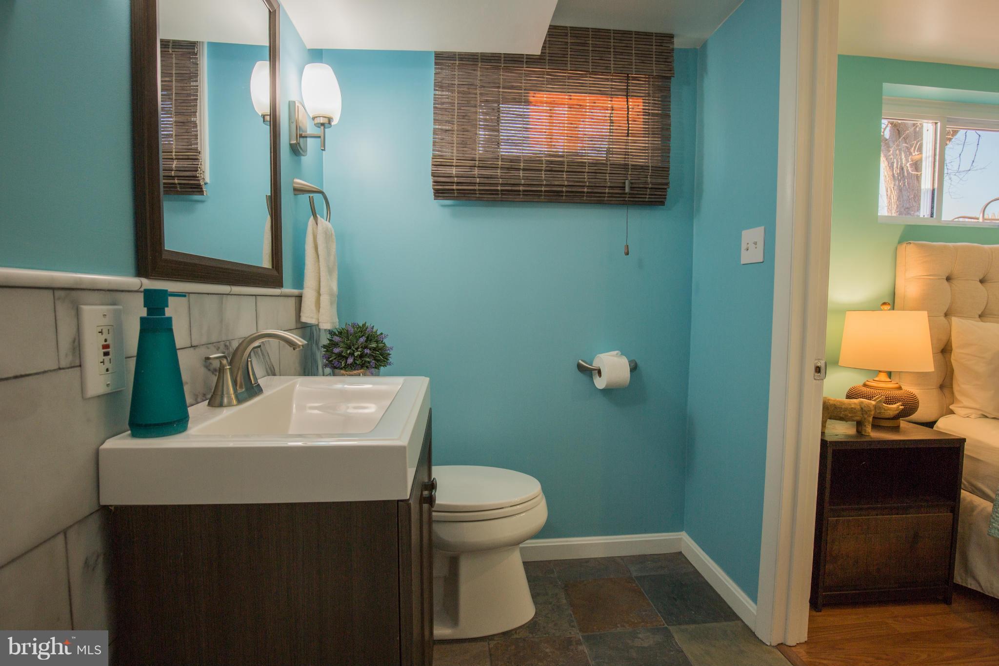 12716 Feldon Street Silver Spring, MD 20906 - Photo 27 of 30 a bathroom with a sink a toilet and mirror