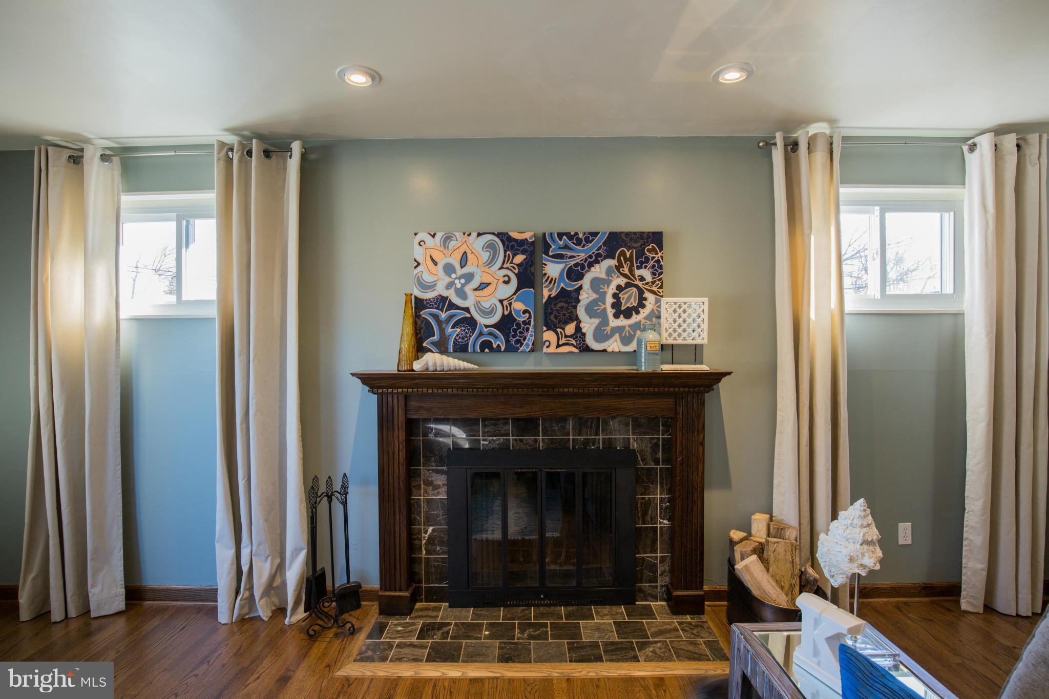 12716 Feldon Street Silver Spring, MD 20906 - Photo 4 of 30 a living room with furniture and a fireplace