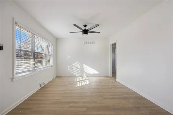 a view of a livingroom with a ceiling fan and window