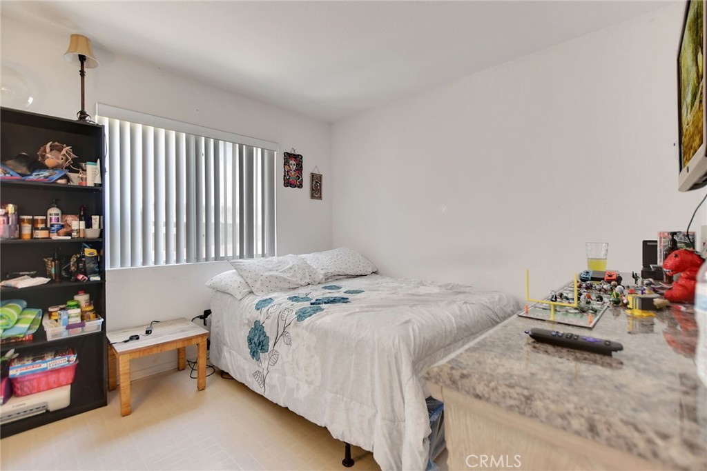 24880 Balestrieri Road Hemet, CA 92544 - Photo 17 of 34 a bed sitting in a bedroom next to a window