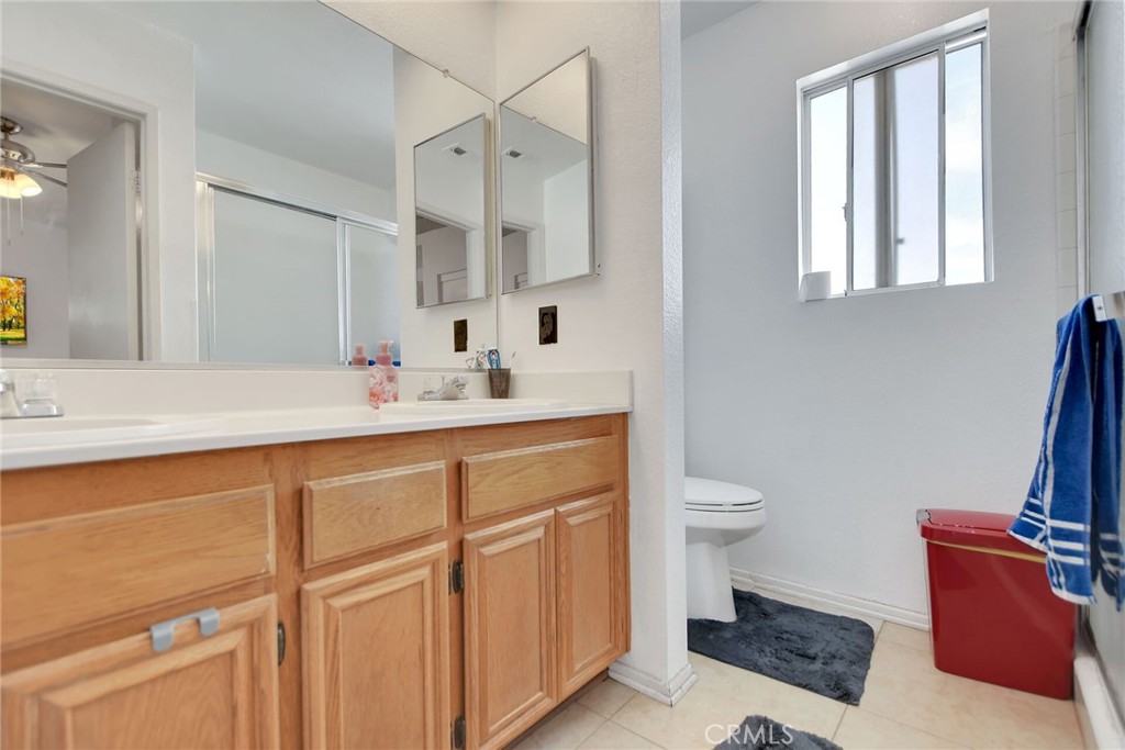 24880 Balestrieri Road Hemet, CA 92544 - Photo 18 of 34 a bathroom with a sink a toilet and a mirror