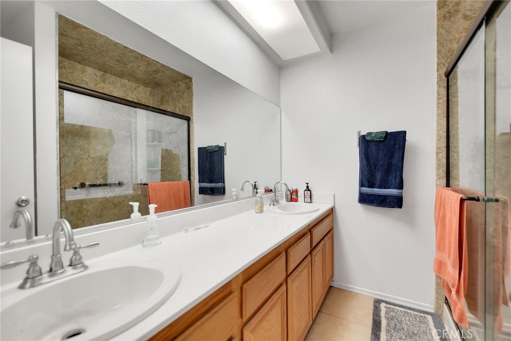 24880 Balestrieri Road Hemet, CA 92544 - Photo 21 of 34 a bathroom with a double vanity sink and mirror