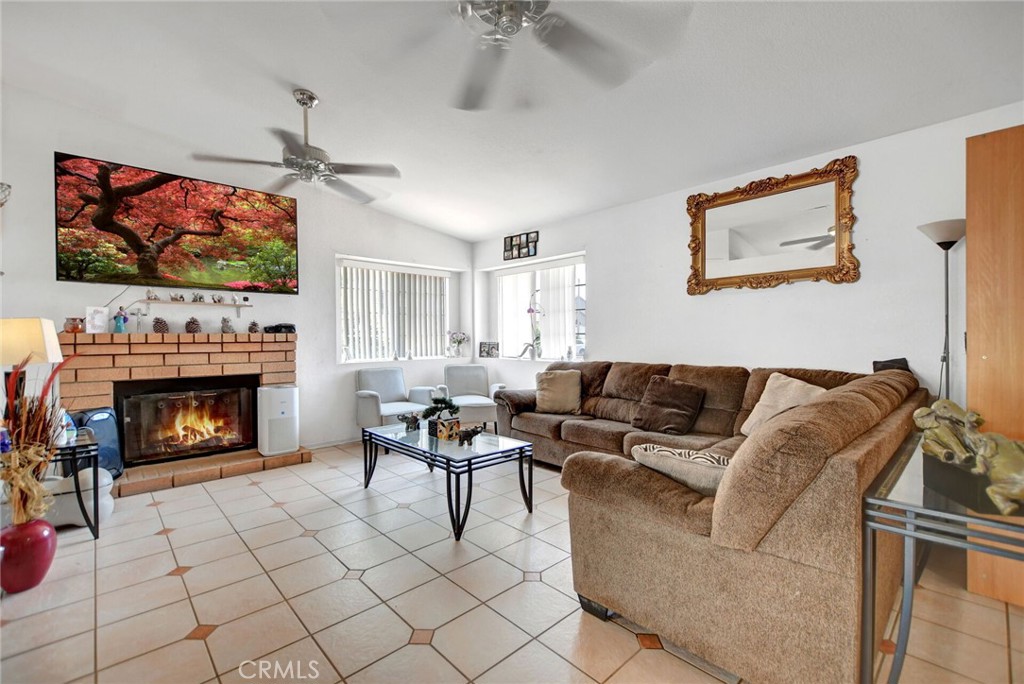 24880 Balestrieri Road Hemet, CA 92544 - Photo 6 of 34 a living room with furniture a flat screen tv and a fireplace