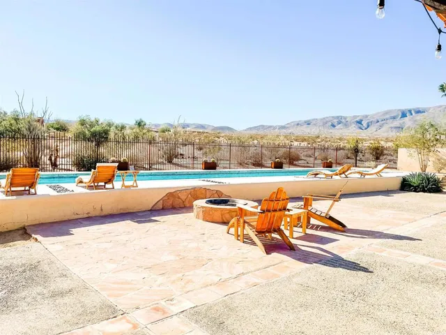 an outdoor space with patio swimming pool and ocean view