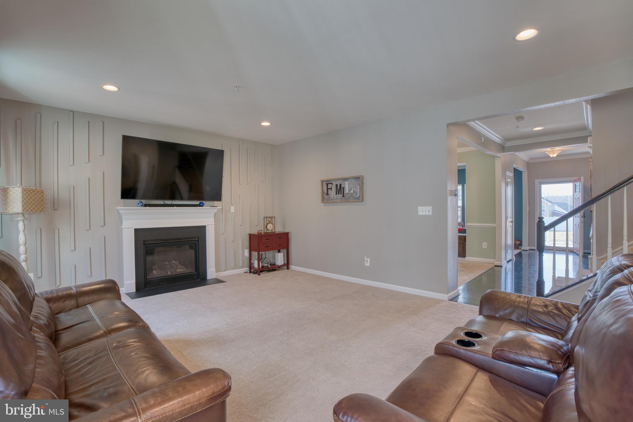 505 Potomac Road Joppa, MD 21085 - Photo 29 of 66 a living room with furniture a fireplace and a flat screen tv