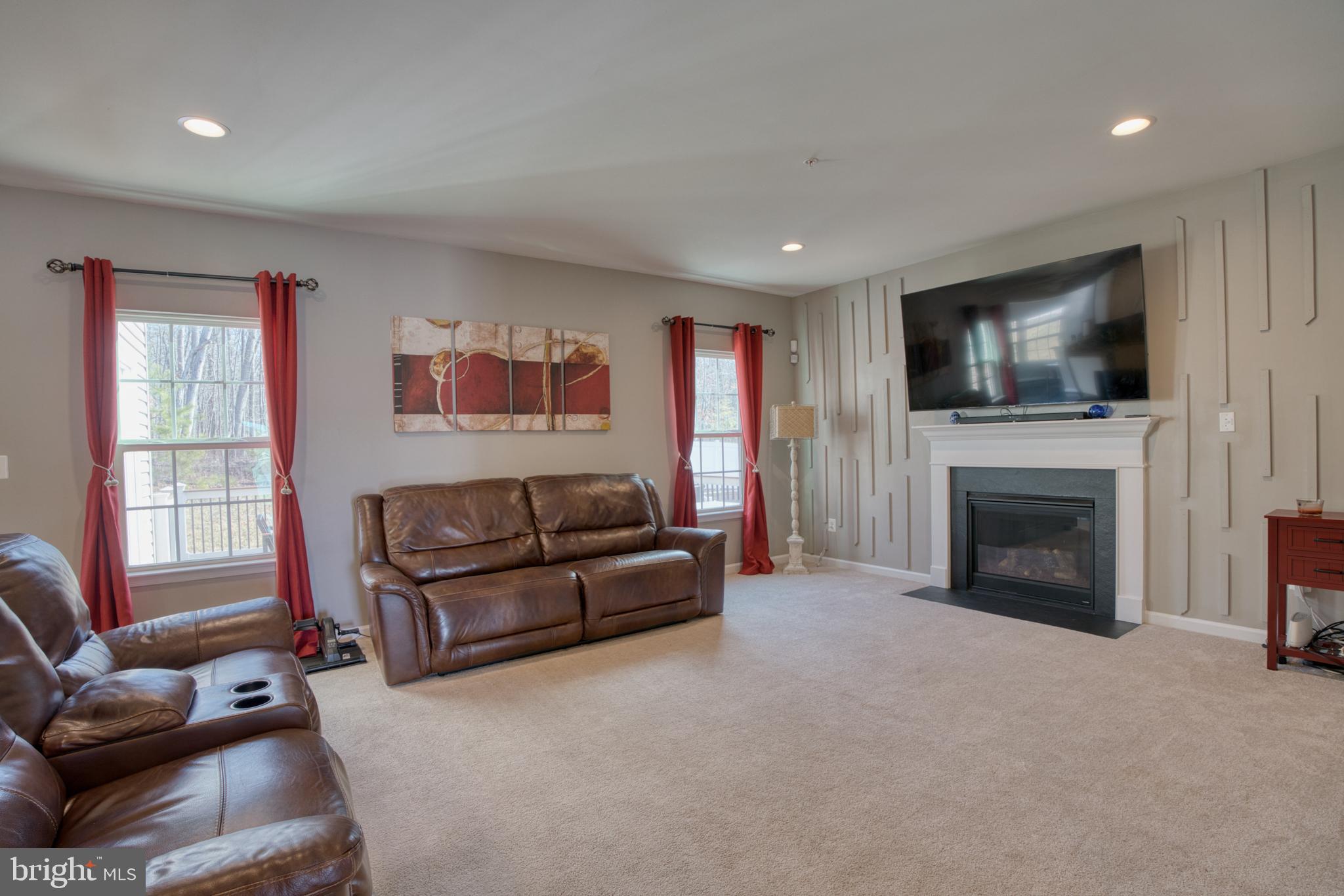505 Potomac Road Joppa, MD 21085 - Photo 32 of 66 a living room with furniture a fireplace and a flat screen tv