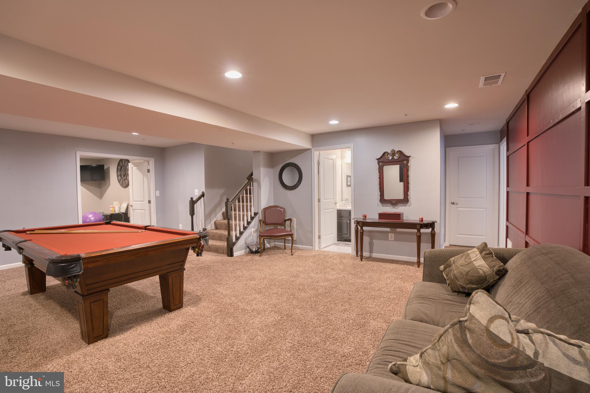 505 Potomac Road Joppa, MD 21085 - Photo 38 of 66 a room with furniture a flat screen tv and gym equipment