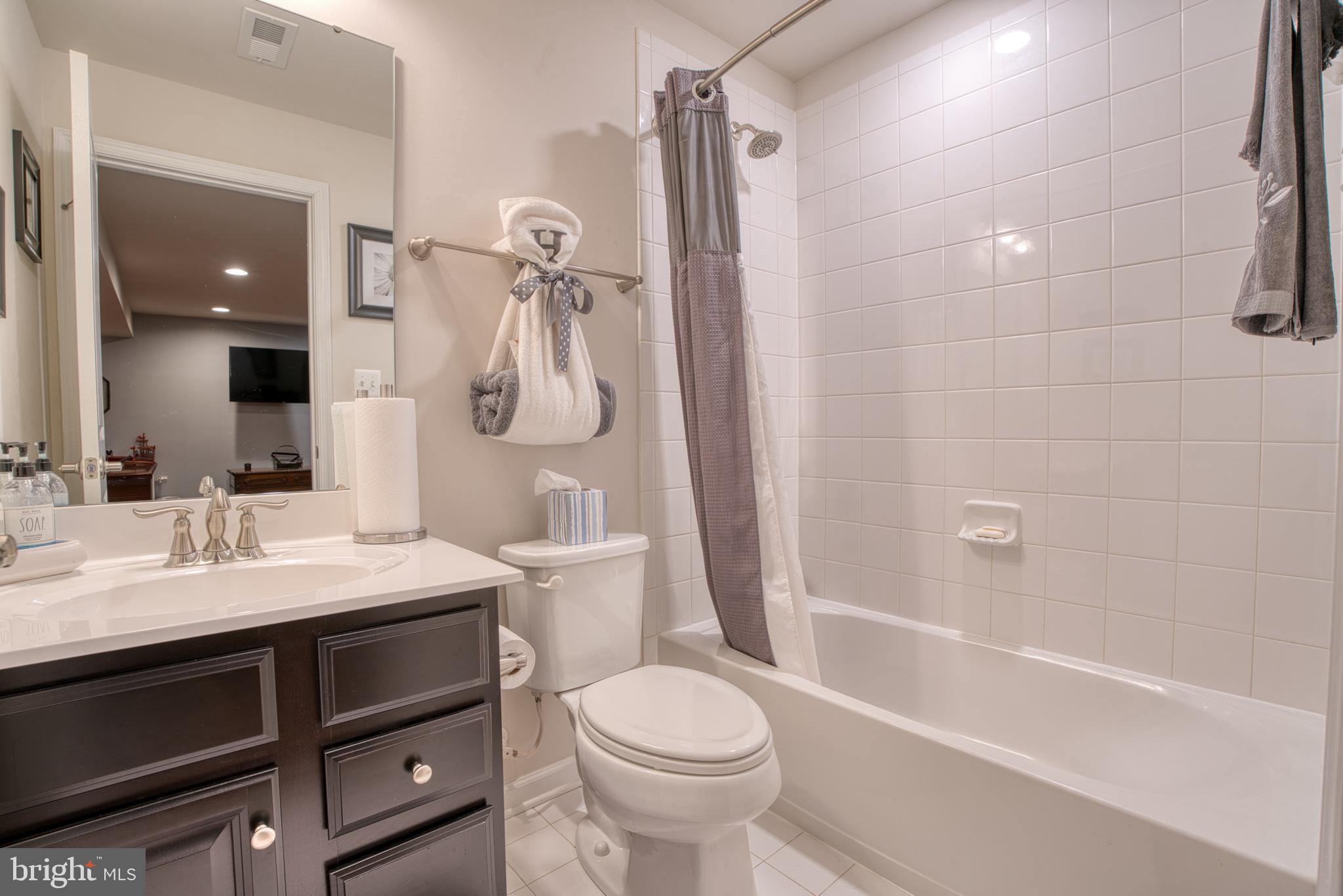 505 Potomac Road Joppa, MD 21085 - Photo 39 of 66 a bathroom with a sink toilet vanity and shower