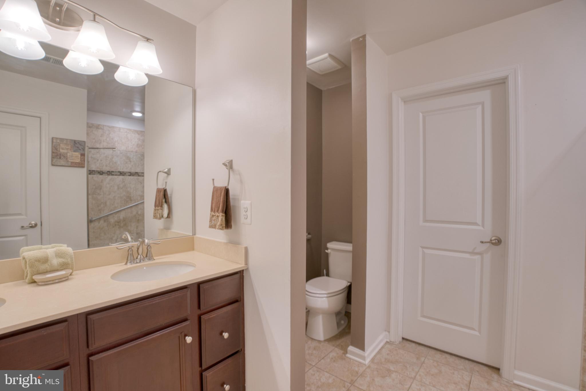 505 Potomac Road Joppa, MD 21085 - Photo 50 of 66 a bathroom with a toilet a sink and mirror