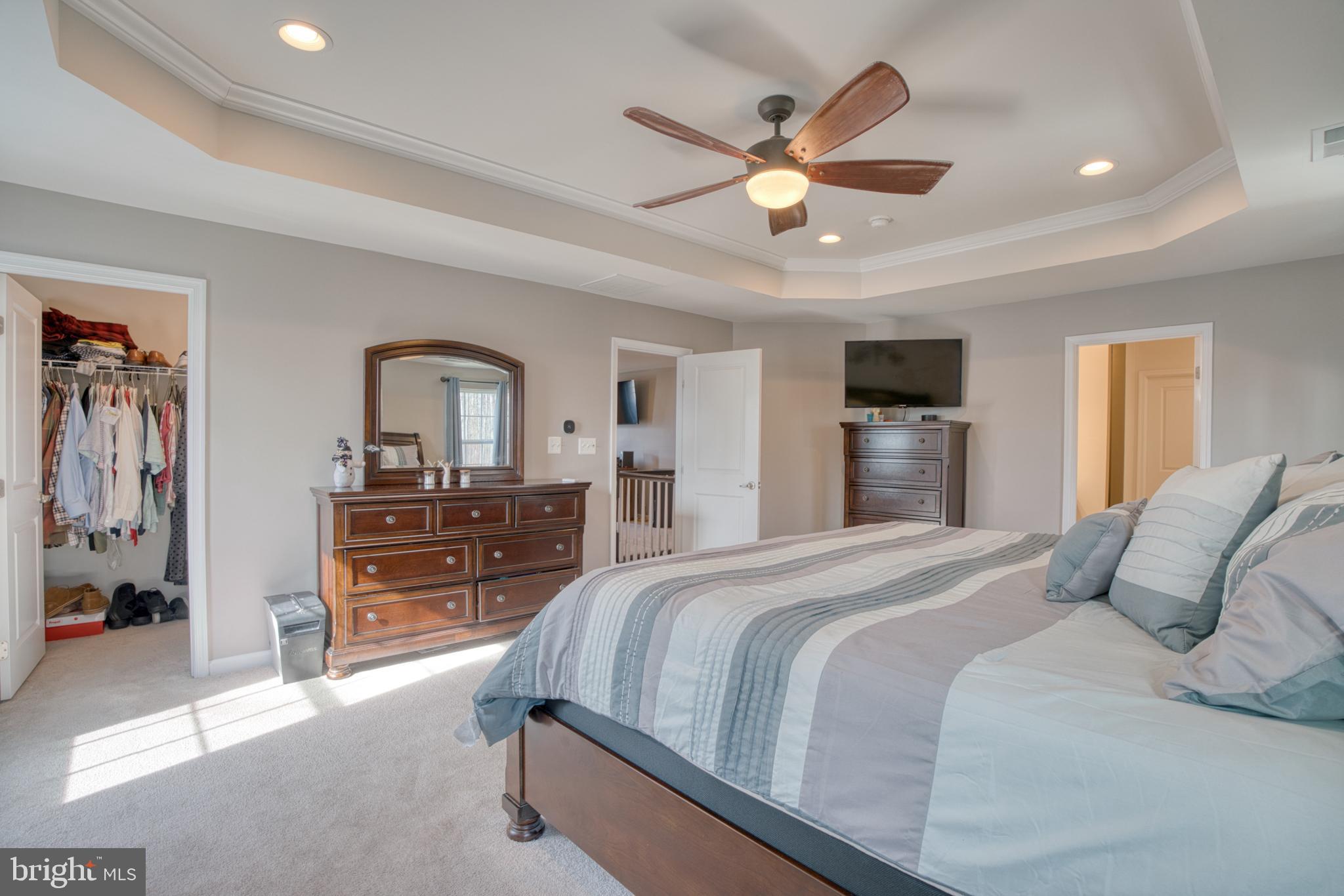 505 Potomac Road Joppa, MD 21085 - Photo 55 of 66 a bedroom with a large bed and a chandelier