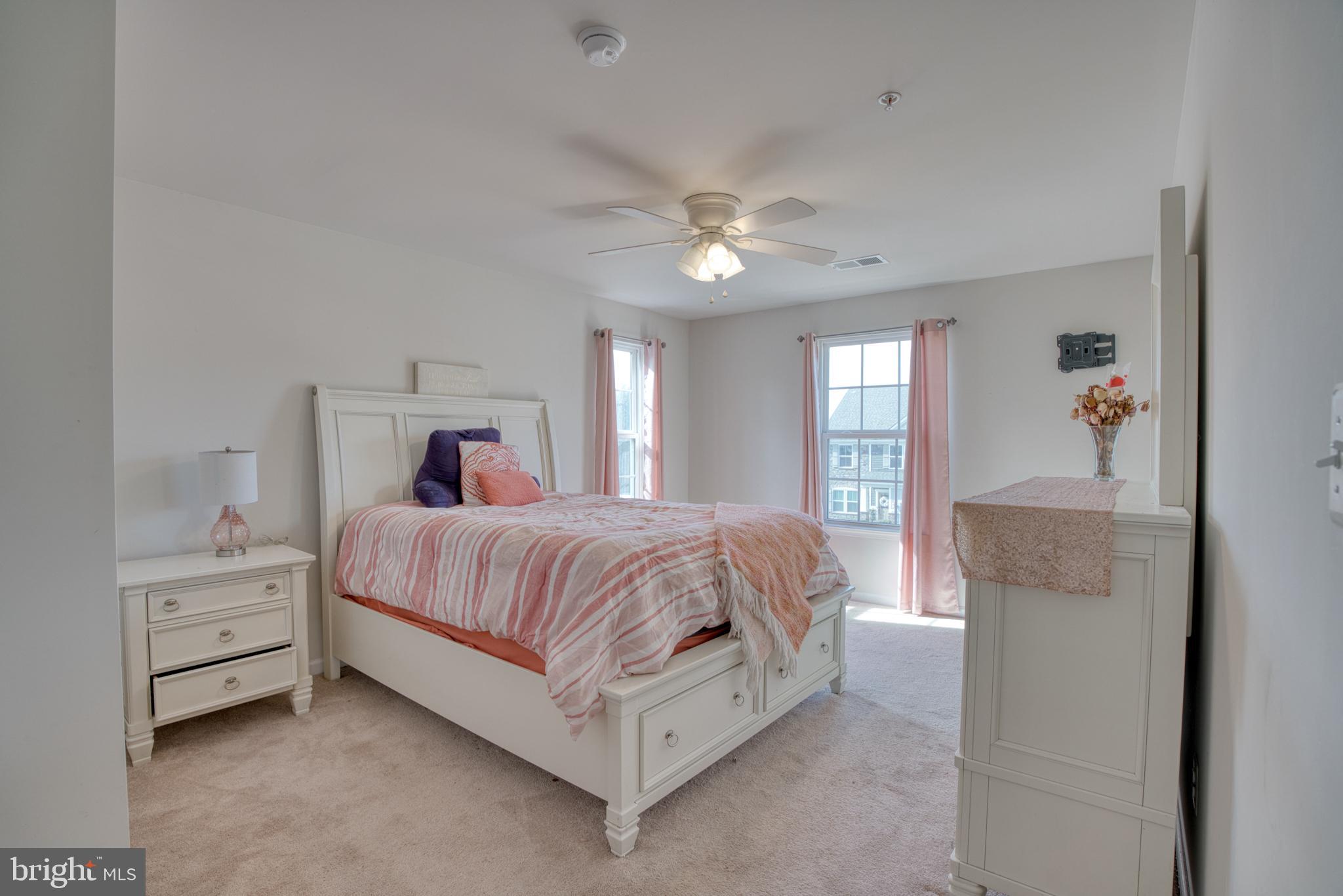 505 Potomac Road Joppa, MD 21085 - Photo 61 of 66 a spacious bedroom with a bed and a chandelier