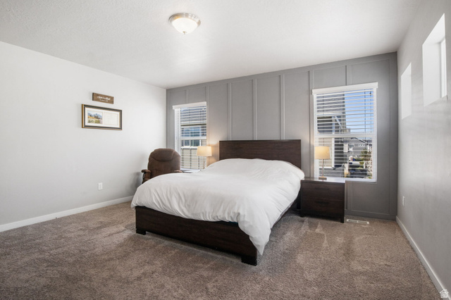 5155 East Rio Grande Way Eagle Mountain, UT 84005 - Photo 16 of 40 Bedroom with a decorative wall and carpet floors