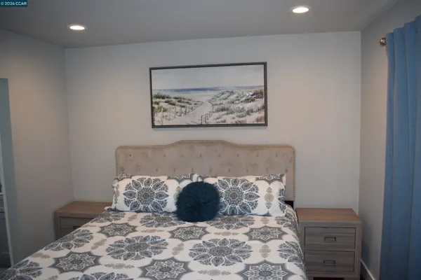 a large bed sitting in a bedroom next to a cabinet