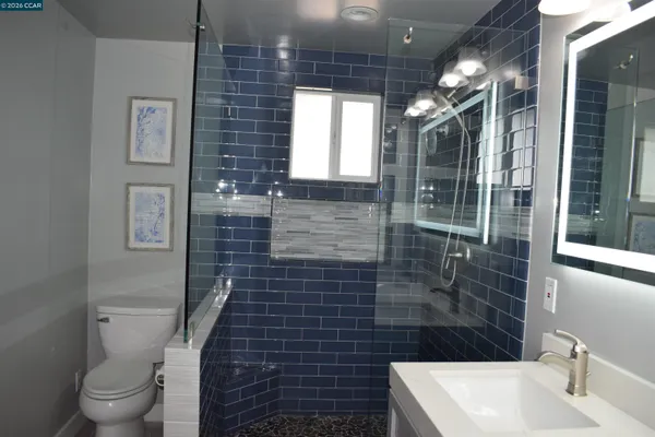 a bathroom with a toilet a sink and shower