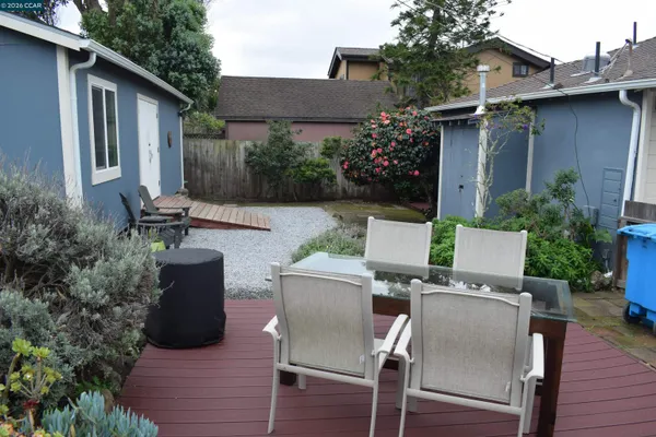 a view of backyard of house with seating space and plants