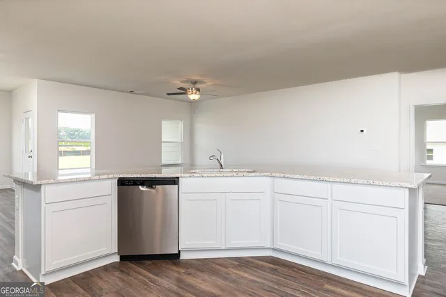 a kitchen with a sink cabinets and appliances