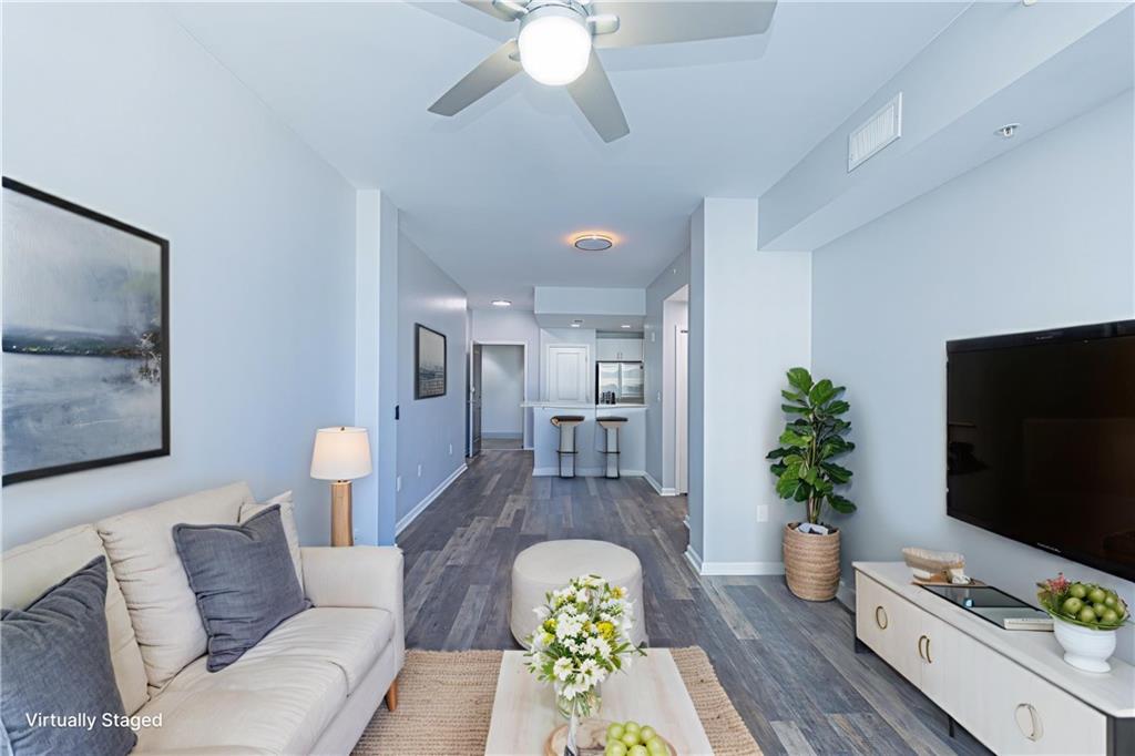 3040 Peachtree Road Northwest, Unit 613 Atlanta, GA 30305 - Photo 1 of 30 a living room with furniture and a flat screen tv