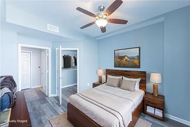 a bedroom with a bed and a chandelier