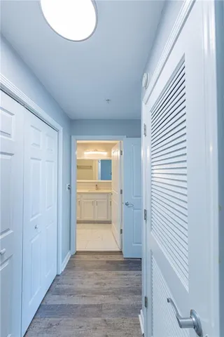 a view of empty room with wooden floor