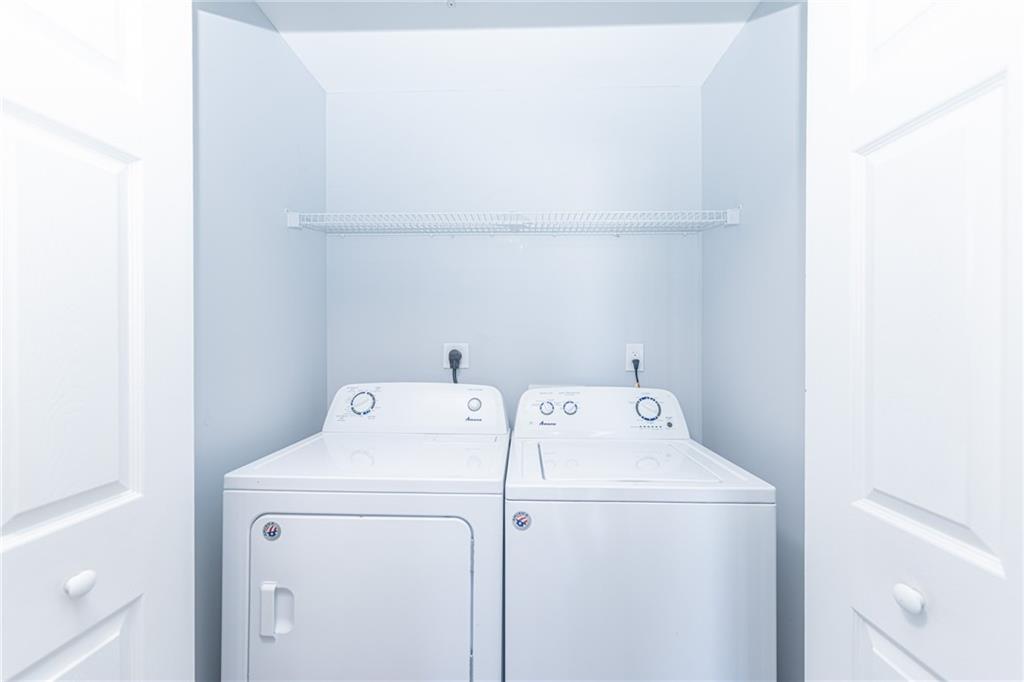3040 Peachtree Road Northwest, Unit 613 Atlanta, GA 30305 - Photo 13 of 30 a utility room with dryer and washer