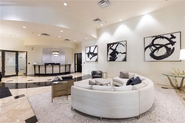 a living room with furniture and a large mirror