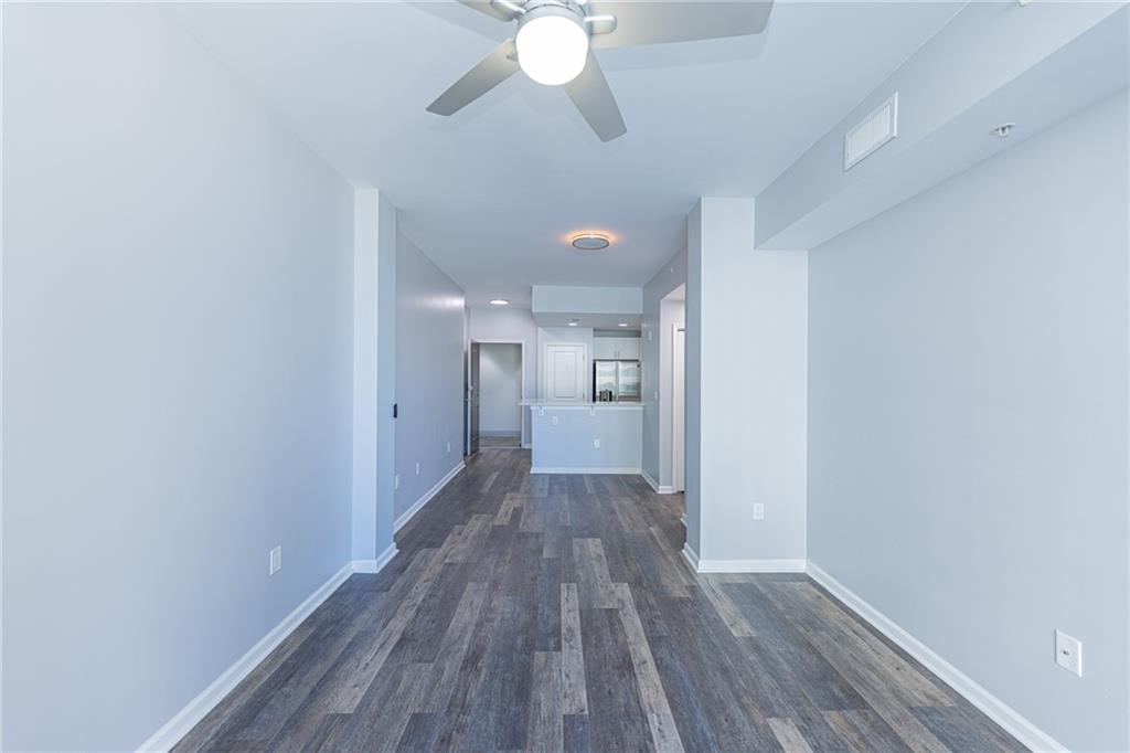 3040 Peachtree Road Northwest, Unit 613 Atlanta, GA 30305 - Photo 2 of 30 a view of a big room with wooden floor and a chandelier fan
