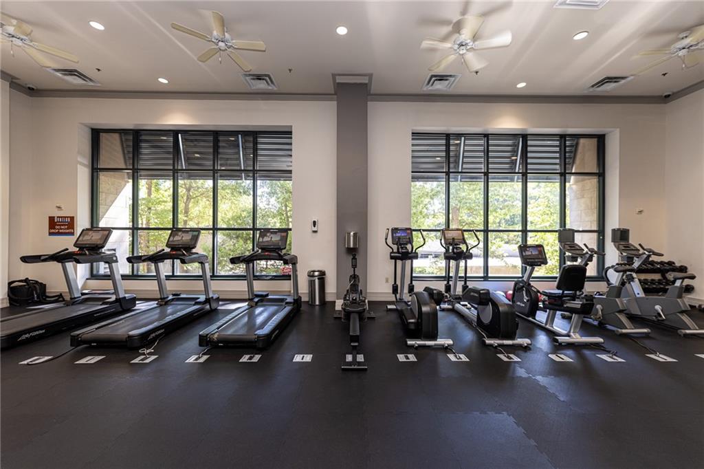 3040 Peachtree Road Northwest, Unit 613 Atlanta, GA 30305 - Photo 22 of 30 a room with gym equipment and large windows
