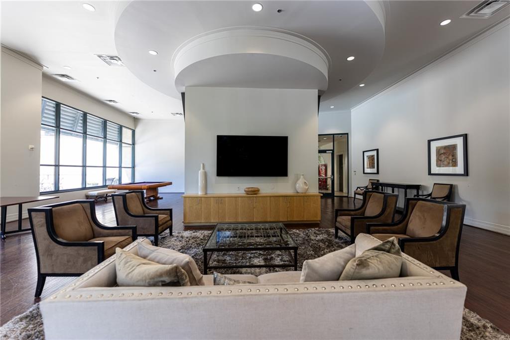 3040 Peachtree Road Northwest, Unit 613 Atlanta, GA 30305 - Photo 26 of 30 a living room with furniture and a flat screen tv