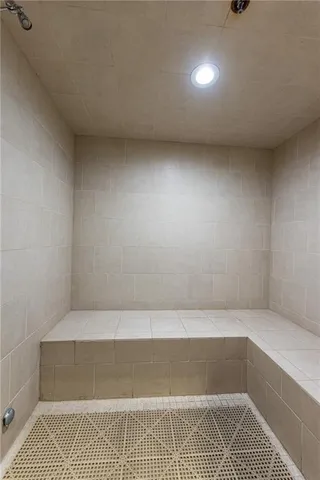 a living room with furniture and floor to ceiling windows