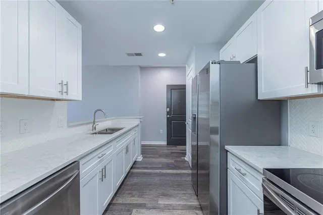 a kitchen with a sink and refrigerator