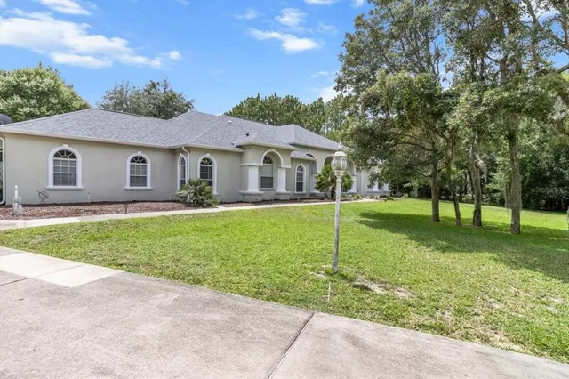 a view of a house with a backyard