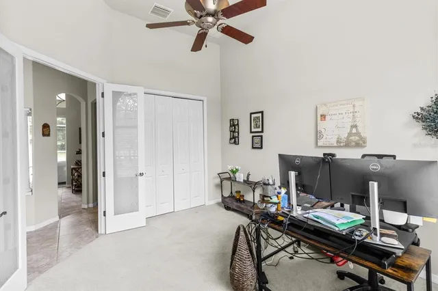 a dining room with furniture a chandelier and wooden floor