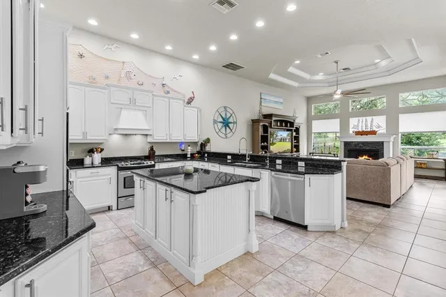 a kitchen with stainless steel appliances granite countertop a sink and cabinets
