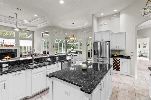 a dining room with furniture a chandelier and window