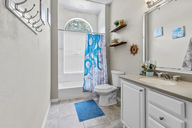 a view of a kitchen with fridge and wooden floor