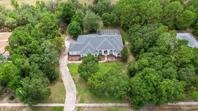 an aerial view of a house with a yard