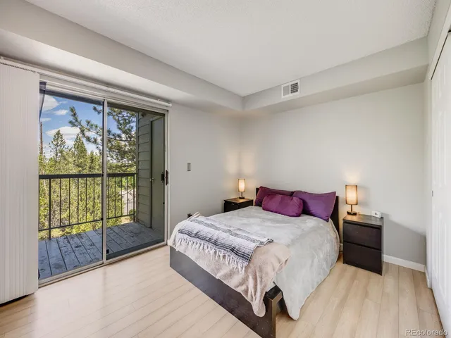 a bedroom with a large bed and a large window