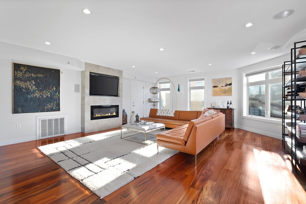 112 West 9th Street, Unit PH4 Boston, MA 02127 - Photo 11 of 34 a living room with furniture fireplace and wooden floor