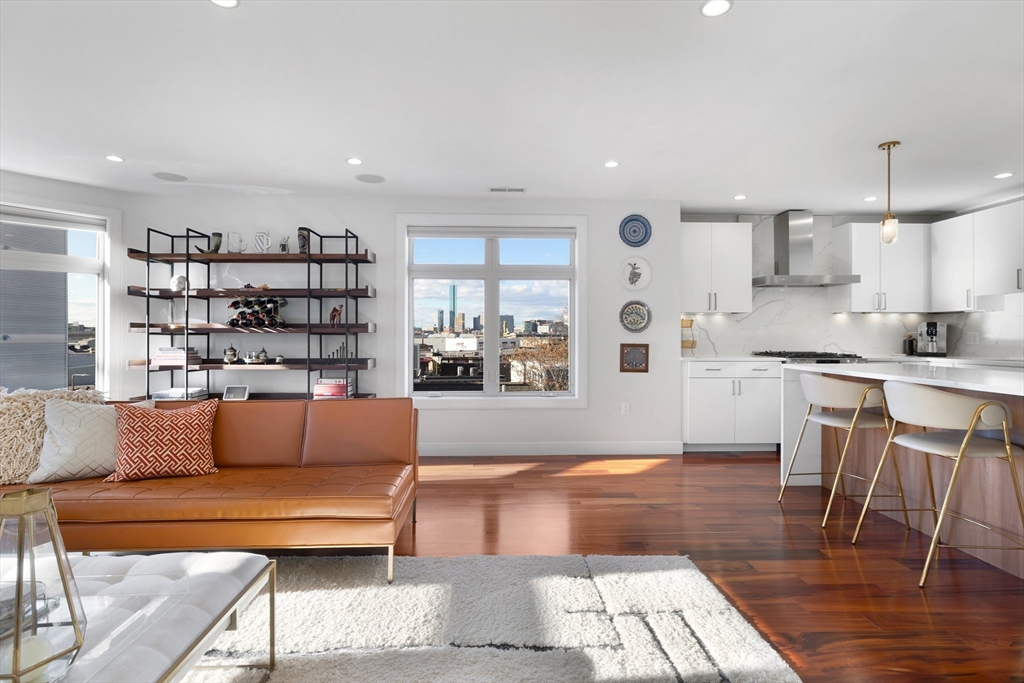 112 West 9th Street, Unit PH4 Boston, MA 02127 - Photo 12 of 34 a living room with stainless steel appliances furniture and a kitchen view
