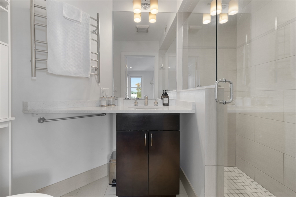 112 West 9th Street, Unit PH4 Boston, MA 02127 - Photo 16 of 34 a bathroom with a sink vanity and a mirror