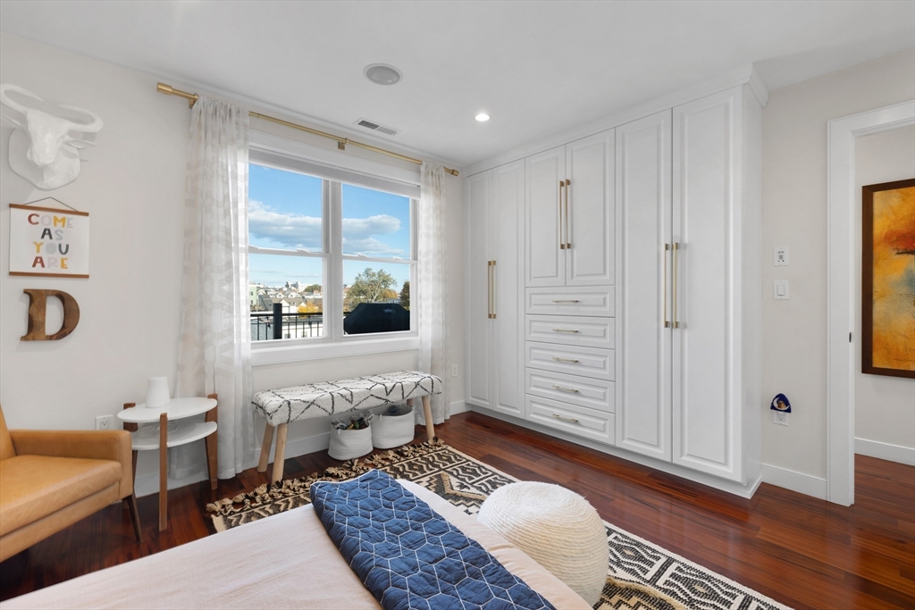 112 West 9th Street, Unit PH4 Boston, MA 02127 - Photo 19 of 34 a spacious bedroom with a bed a couch and a window