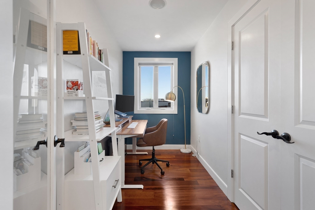 112 West 9th Street, Unit PH4 Boston, MA 02127 - Photo 21 of 34 a workspace with furniture and wooden floor