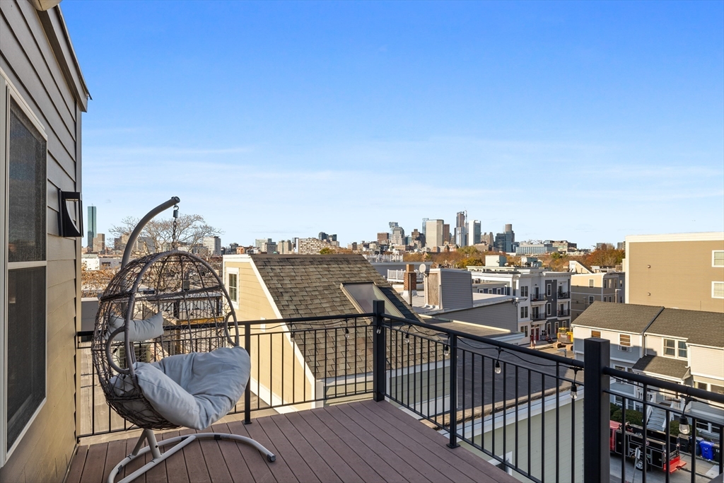 112 West 9th Street, Unit PH4 Boston, MA 02127 - Photo 26 of 34 a view of a balcony with wooden chairs