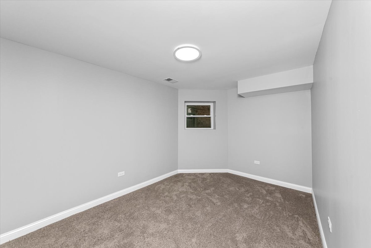 7819 South Morgan Street, Unit G Chicago, IL 60620 - Photo 6 of 13 an empty room with a workbench