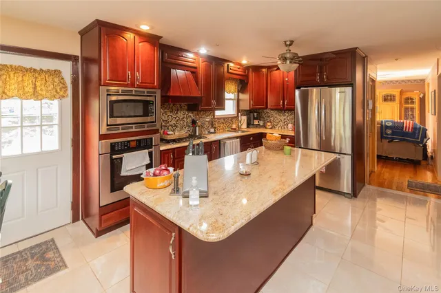 a view of a living room with furniture and a chandelier