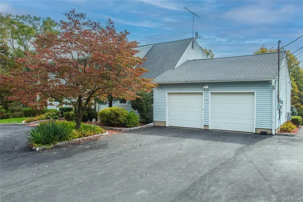a view of a house with a yard and garage