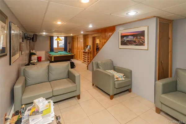 a room with pool table and windows