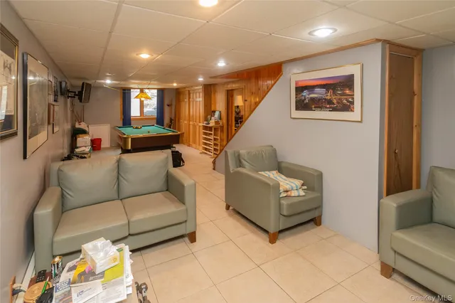 a room with pool table and windows