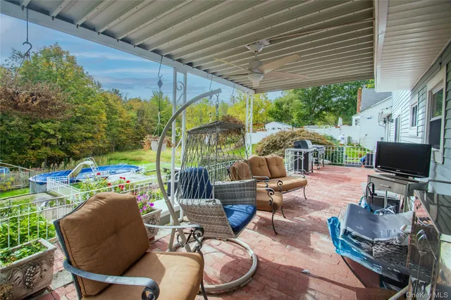 a patio outdoor space with patio furniture and potted plants