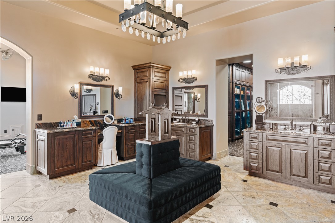 1123 Christian Road Henderson, NV 89002 - Photo 24 of 94 Luxurious tile flooring and rich wood cabinetry define this lavish dressing area, complete with multiple vanities.